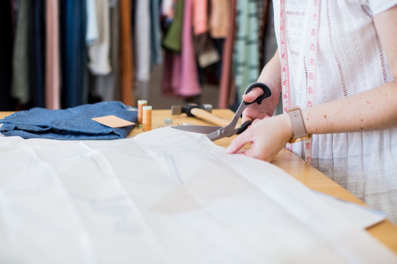 Cutting out a pattern at the workroom table